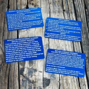 blue Indiana Miranda, Pirtle, Implied Consent, And Fatal Or Serious Injury Implied Consent Metal Cards on a wooden table