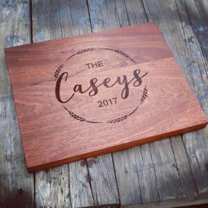 A custom cutting board with "The Caseys 2017" engraved on it
